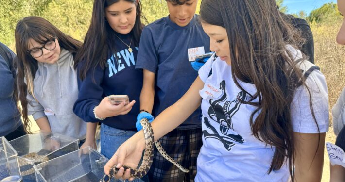 Acorns to oaks Students holding snake